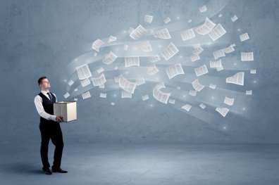 Dozens of sheets of paper flying out of a cardboard box