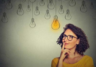 Businesswoman with a lightbulb over her head conceptual image of rethinking document strategy