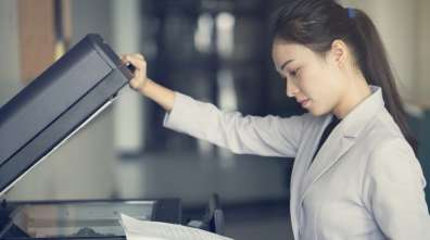 Woman opening an office copier