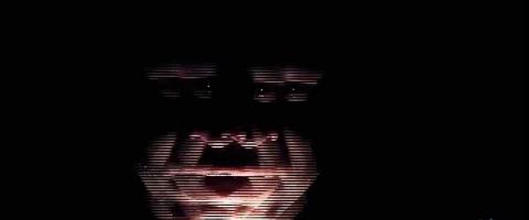 Stylized image of man's face in the dark only lighted from below