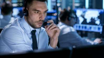 Employee with headset talking on phone to customer