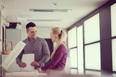 man and woman using office printer