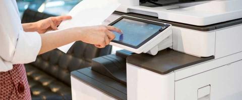 close up of a professional woman interacting with a business copier's interface