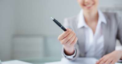 Cropped image of woman handing over a pen