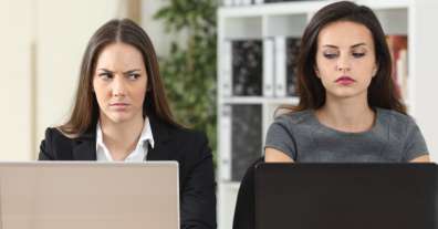 woman looking at another woman's laptop computer