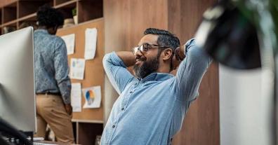 satisfied business man beard glasses mac