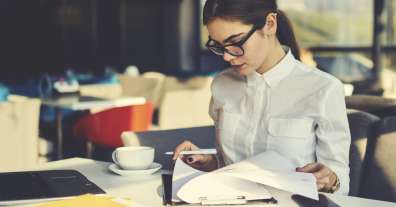 professional woman reviewing paper document