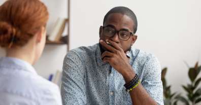 Two coworkers looking at each other in meeting