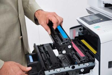 Employee holding a toner cartridge