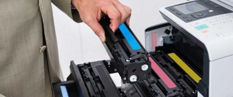 Employee holding a toner cartridge