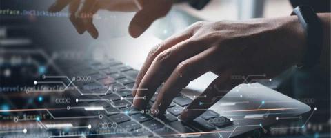 Conceptual image of IT Services Provider with a close up of hands working on a laptop. 