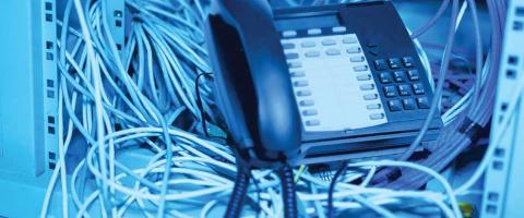 Telephone in front of a bunch of wires