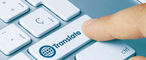 Man pointing at "Translate" button on a keyboard