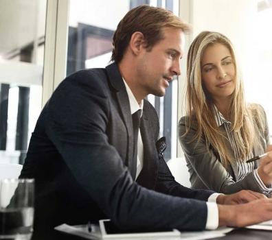 Two employees looking at something together 