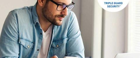 Man looking at computer screen in home office