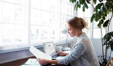 Woman working on laptop computer in home office