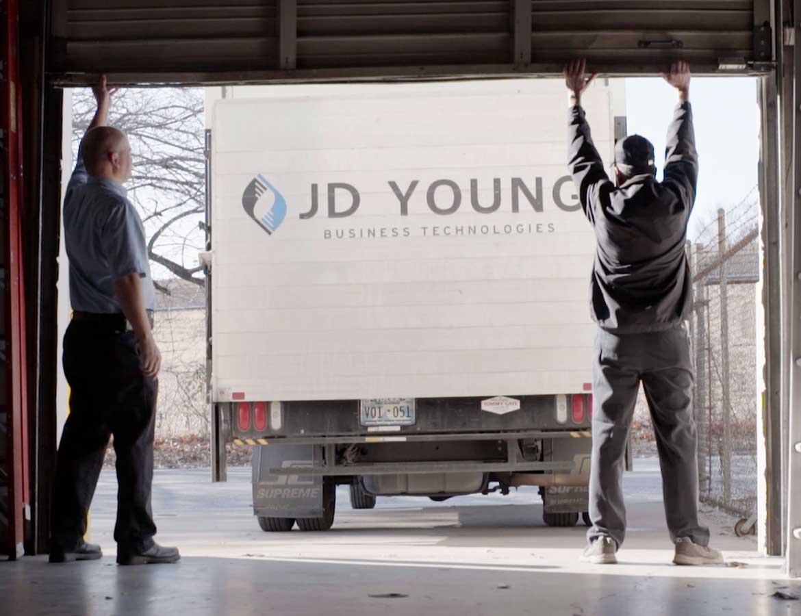 jd young delivery drivers loading truck with products